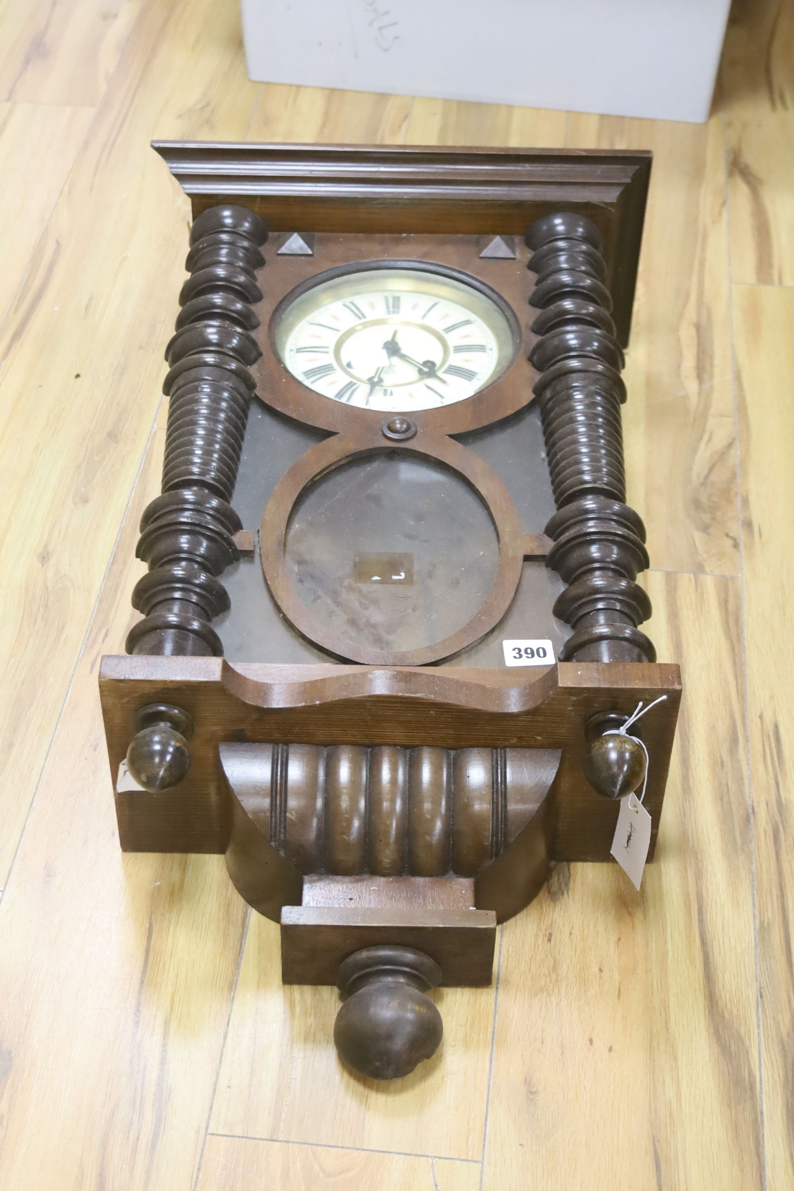 A 19th century Continental wall clock, in architectural walnut case, with key and pendulum, 95cm